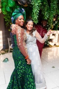 two lady friends holding each other and smiling