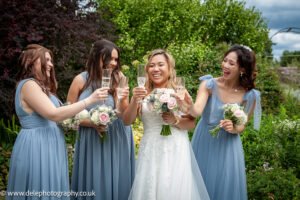 Women standing with a bride holding a glass cup in their hands
