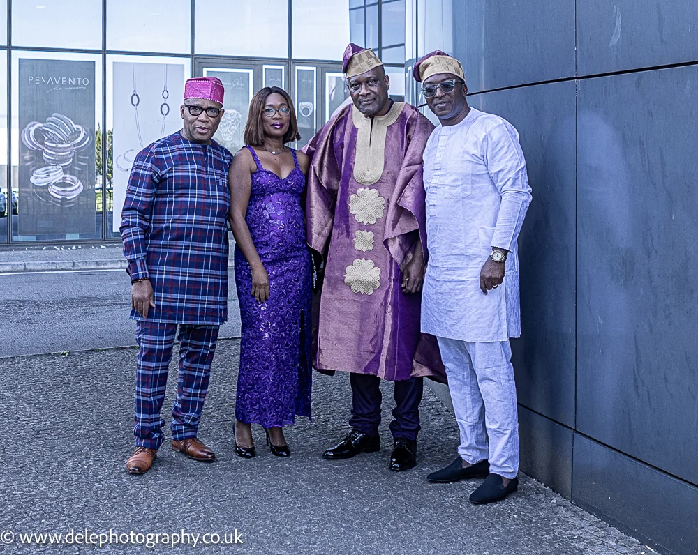 picture of three men and a woman standing