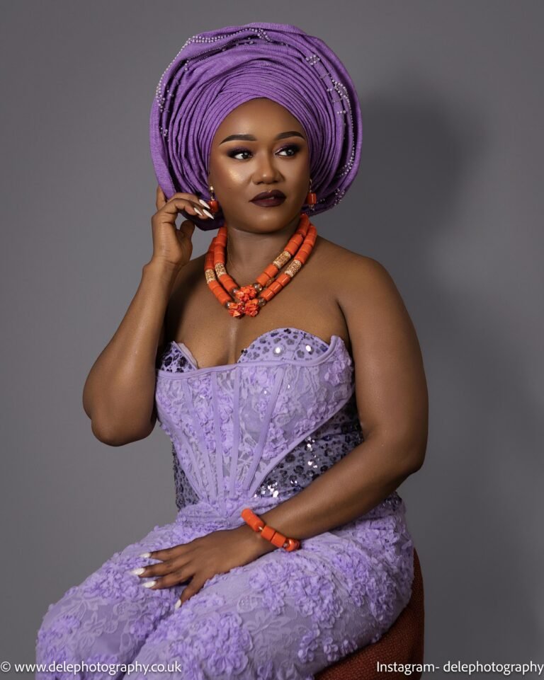 An African woman in traditional light purple atire