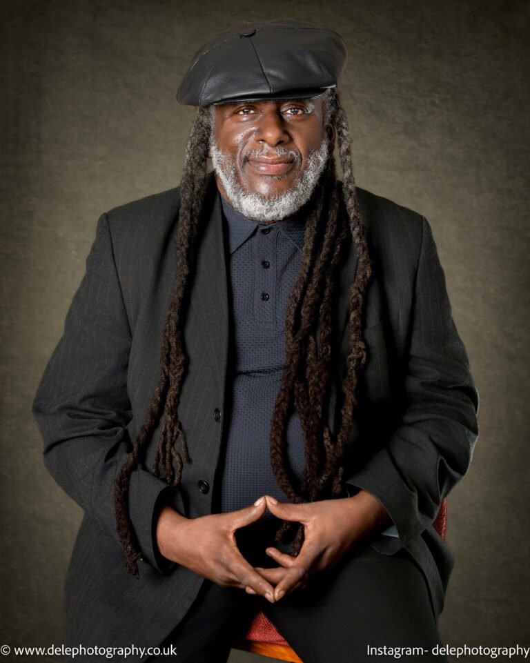 A portrait photo of a black man with white beards