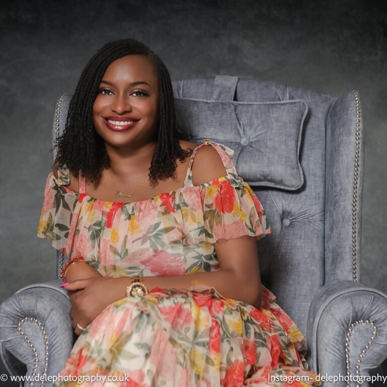 lady seating on an executive chair and smiles to the camera